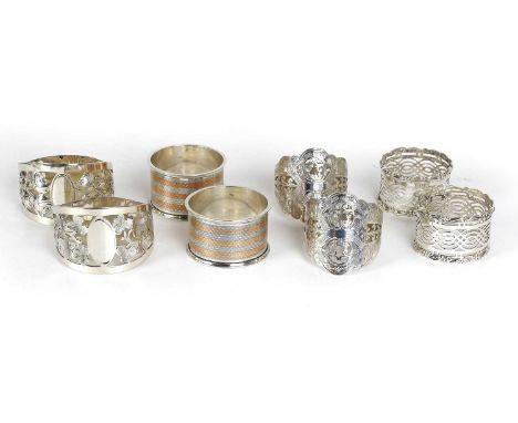 Eight Assorted Silver Napkin-Rings, including three pairs, one pair with parcel-gilt engine-turned decoration, the other two 