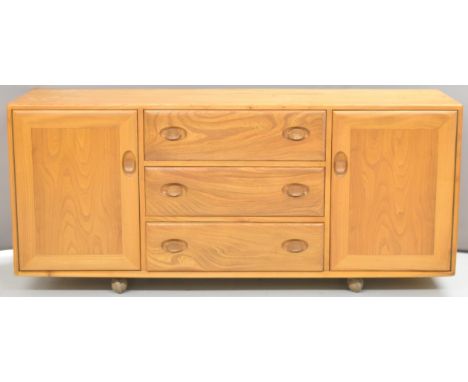 Ercol light elm mid century modern low sideboard with three drawers flanked by two cupboards, W155 x D44 x H68cm