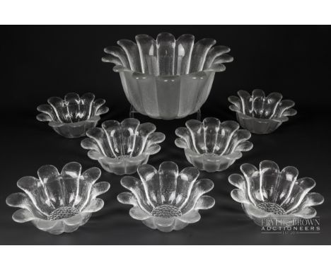 A vintage part fruit dessert set, the clear glass bowls moulded in the form of stylised flowers, comprising serving dish and 