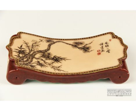 A fine Chinese porcelain scholar's pen rest/scroll weight, with an iron red four character Qianlong seal mark, decorated to t