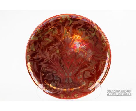 An Arts & Crafts Maw and Co., Jackfield, ruby lustre charger decorated with a satyr's head amidst stylised foliage, 33.5cm di