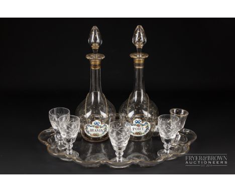 A glass tray with gilt rim and all over gilt star decoration, with two small conforming decanters and one glass; four other g