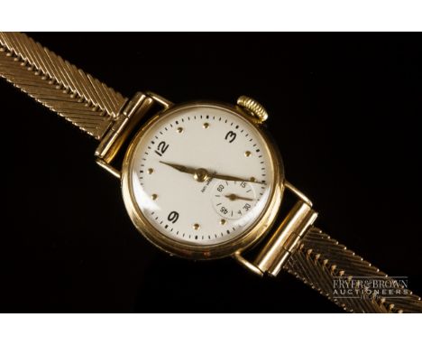 A vintage ladies 9ct gold wristwatch, the circular silver dial with subsidiary seconds dial, on a 9ct yellow gold herringbone