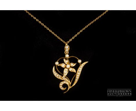 A split pearl and 18ct gold pendant, c1890, of stylised lily design, on a trace link chain