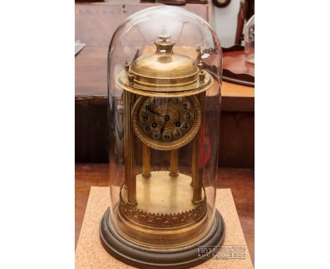 A French gilt brass clock of neoclassical design, the circular dial with black enamel numerals in silvered circles, on fluted