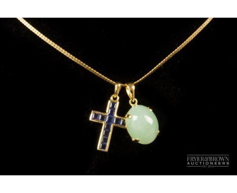 An 18ct yellow gold and calibre cut sapphire cross pendant; and an 18ct gold and cabochon pale green coloured jade pendant on