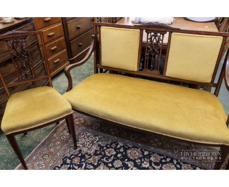 An Edwardian mahogany salon suite, comprising four splat back side chairs with satinwood banding and two seater sofa with sti