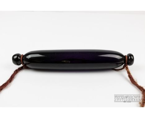 A dark amethyst glass rolling pin frigger, c1860, 34.5cm long