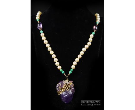An 18 carat gold, cultured pearl, amethyst and turquoise pendant necklace, the Chinese carved fruiting peach pendant with gol