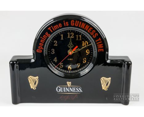 A Guinness Diamond Print Ceramics mantel clock, black and printed with 'Opening Time is Guinness Time', quartz movement, 31.5