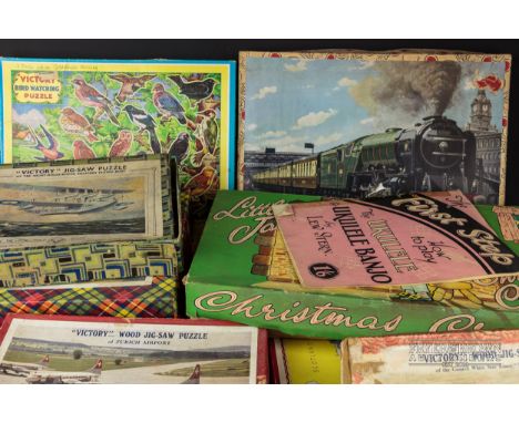A quantity of vintage jigsaw puzzles, including Victory Flying Scotsman and Cunard White Star Line Ship Mauretania wood puzzl