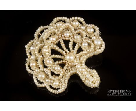 A 19th century seed pearl and mother of pearl fan shaped brooch
