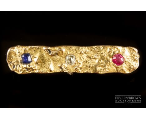 An antique gold, ruby, sapphire and diamond brooch, c1900, the naturalistic finish gold brooch set with a cushion sapphire, d