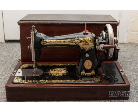 A vintage Singer sewing machine, in mahogany box