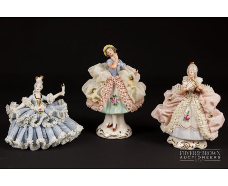 Two small Dresden porcelain lace crinoline figures in Marie Antoinette style; and another, 10.5cm max. (3)
