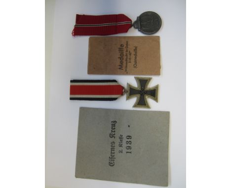 Germany,WW2, Iron Cross Second Class, marked (L/13) with paper packet of issue. Eastern Front medal, with paper packet of iss