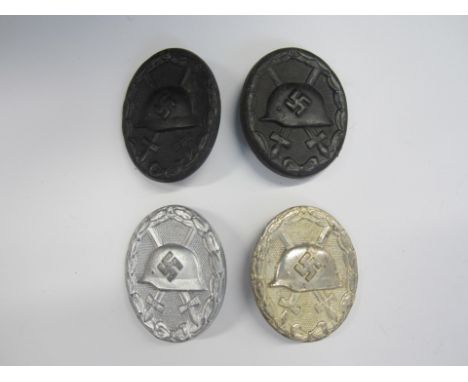 Germany,WW2 period wound badges, black (2), silver (2). Light rust to the first two, otherwise very fine. (4)For further info
