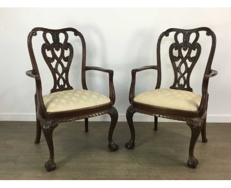 PAIR OF MAHOGANY OPEN ELBOW CHAIRS, of Chippendale design, with moulded and pierced backrest over swept arms, upholstered sea