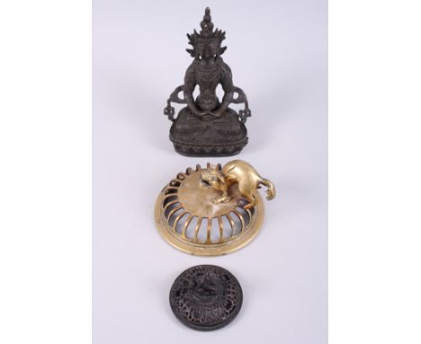 A Tibetan bronzed Buddha, 7 1/2" high, and two pierced jar covers with mythical beasts, 4 1/2" dia, and 2 3/4" dia