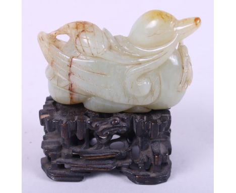 A Chinese carved pale celadon jade figure of a duck, 2 3/4" long, on associated carved hardwood standCondition:The item is ve