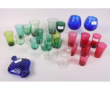 A selection of cranberry and green drinking glasses, two Bristol blue brandy balloons, a similar flask and a custard cup