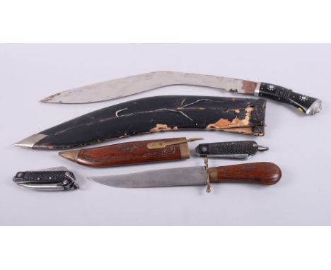 A kukri with engraved blade, a dagger and wooden scabbard and two scout knives