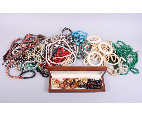 A collection of bead necklaces, including jade, other hardstones, bone, etc and various vintage clip on earrings