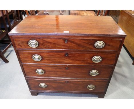 A late Georgian mahogany chest of four long graduated drawers with oval brass handle plates, on bracket feet, 34 1/4" x 36" w