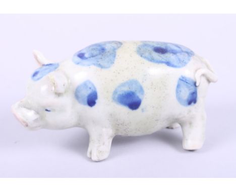 A Chinese blue and white model of a pig with character marks to belly
