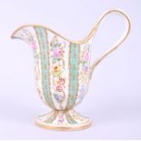 A Sevres porcelain helmet-shaped pedestal cream jug, decorated floral sprays with turquoise and gilt
