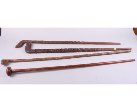 Two Dyak carved walking sticks, a palmwood walking stick and one other hardwood stick