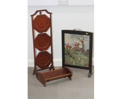 A mahogany three-tier cake stand, a book trough and a needlepoint hunting scene firescreen