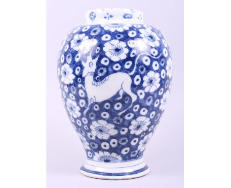 An 18th century English delft oviform jar (cover missing), decorated flowers and deer, 11 1/4" high (restored)