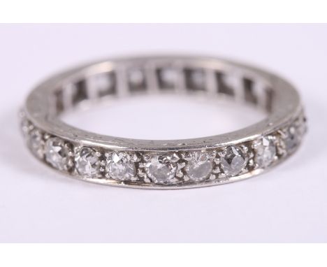 A diamond and white metal full eternity ring with scrolled decoration to the sides, ring size NCondition:Light scratches, no 