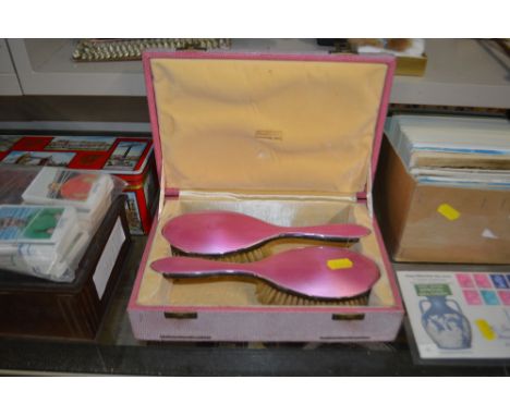 A boxed Harrods silver and enamel brush set 