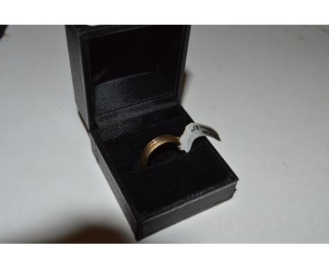 A 9ct gold band - ring size K