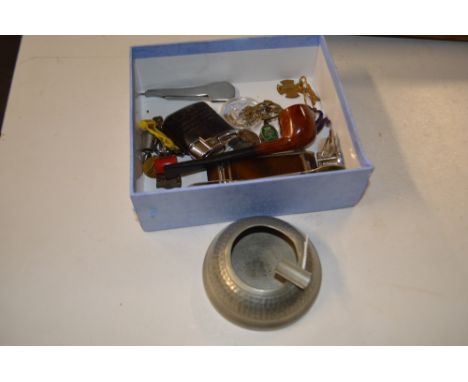 A box containing various enamel and brass badges and brooches; a spot hammered pewter ashtray; cigarette lighter etc.  