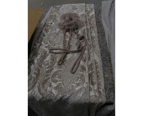 A pair of modern chenille type curtains with tie backs. 