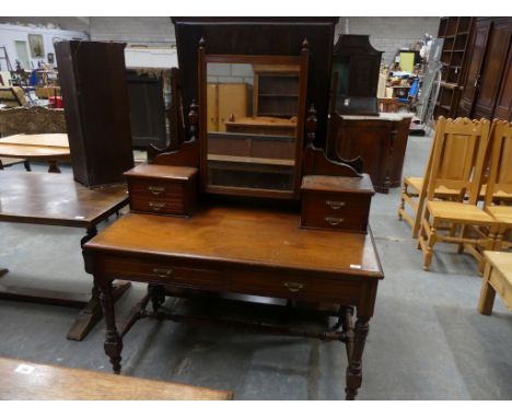 A Victorian walnut dressing table, raised upon ring turned and ring incised supports. 