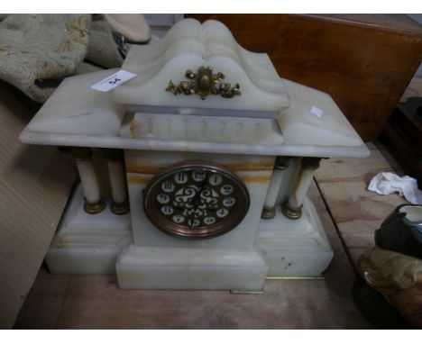 A Victorian alabaster architectural mantle clock with a gilt metal dial and two train movement. 