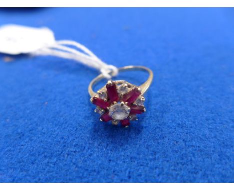 A synthetic ruby and paste cluster ringThe circular shape colourless paste cluster with baguette cut synthetic ruby accents, 