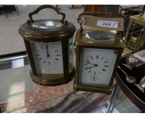 An oval brass cased carriage clock by Matthew Norman of LondonAlong with a second brass cased carriage clock of rectangular f
