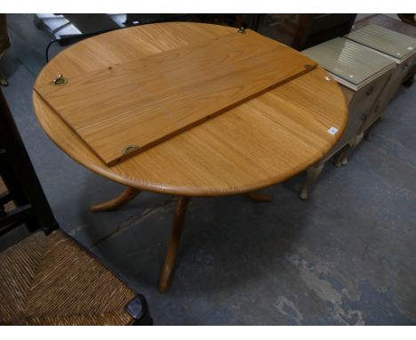 An Ercol light elm oval extending kitchen table.Very good condition.111cm extends to 150cmHeight 72cm  Width 98cm. 