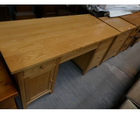 A Contemporary light oak twin pedestal desk with a conforming 3 drawer filing chest. 