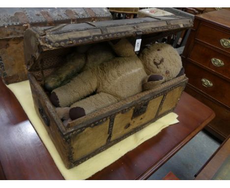 A 19th Century studded leather domed trunk and a collection of vintage Teddy bears. 