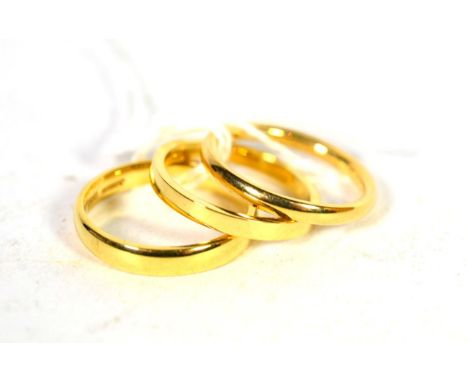 Three 18 carat gold band rings, finger sizes K, L, and L1/2 (3).  Gross weight - 8.19 grams 