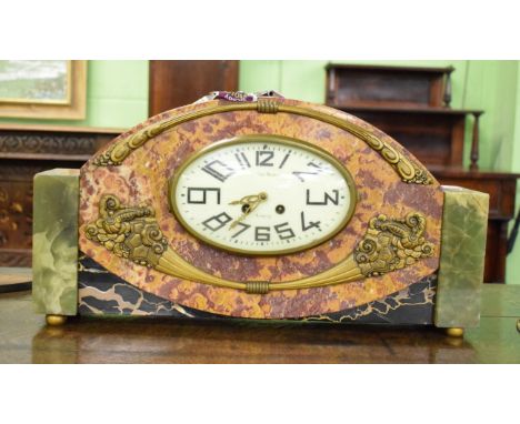 An Art Deco rouge marble and green onyx striking mantel timepiece
