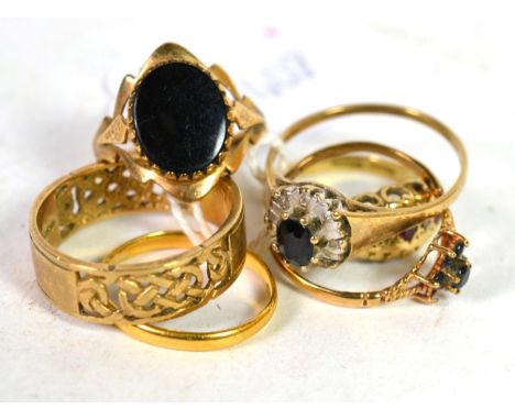 Five 9 carat gold rings including a band ring with pierced decoration, finger size T1/2; an onyx signet ring, finger size L1/