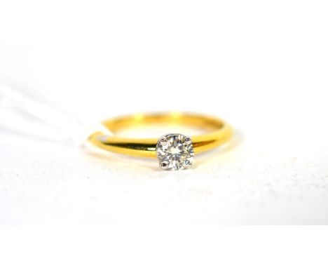 An 18 carat gold solitaire diamond ring, a round brilliant cut diamond in a claw setting, to knife edge shoulders, estimated 