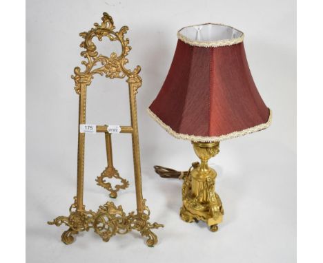 A gilt metal table lamp of urn form decorated with swags together with a reproduction scrolling gilt metal easel (2)